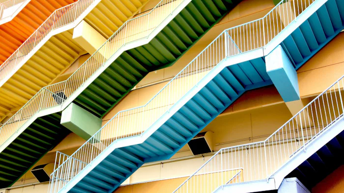 Underbelly of colorful staircases, representing positive narratives.