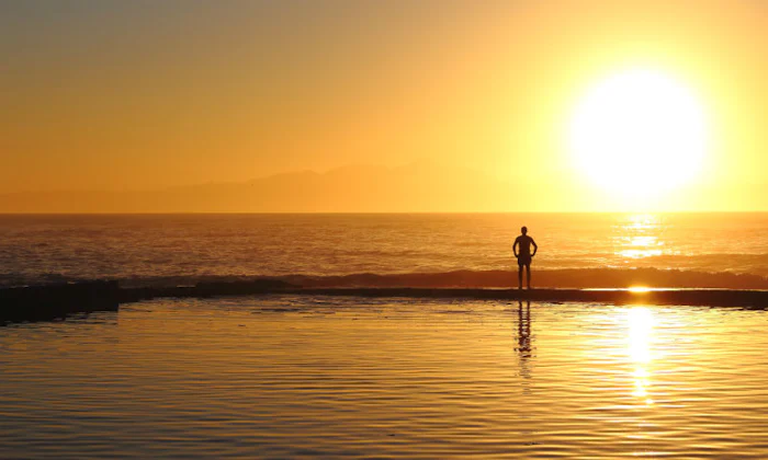 Man on beach at sunset