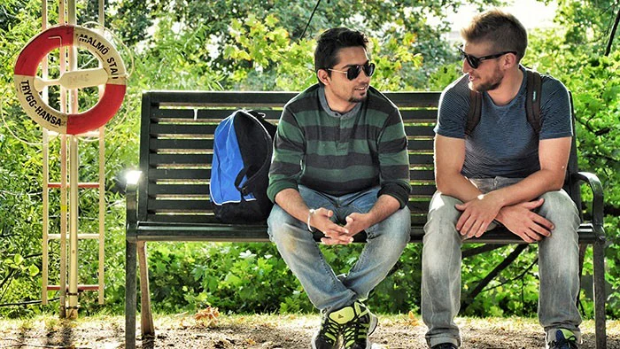 Two men sitting on a bench.