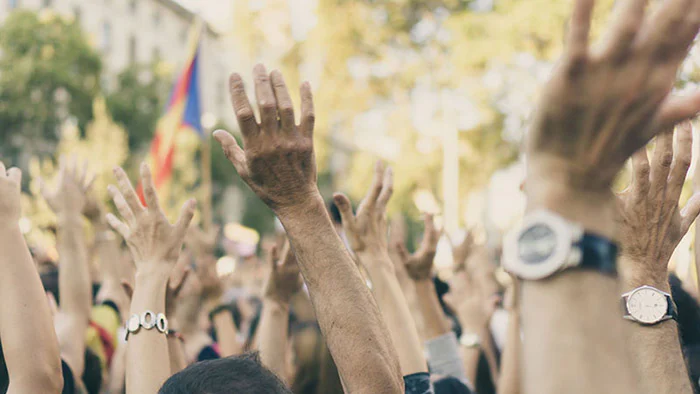 A group of people with their hands up in the air.